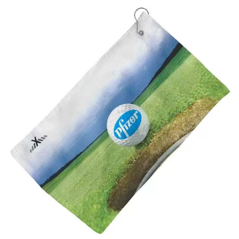 Golf towel printed with a golf course and ball