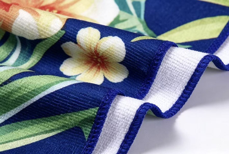 Close-up of blue floral microfiber terry towel with white looped reverse side