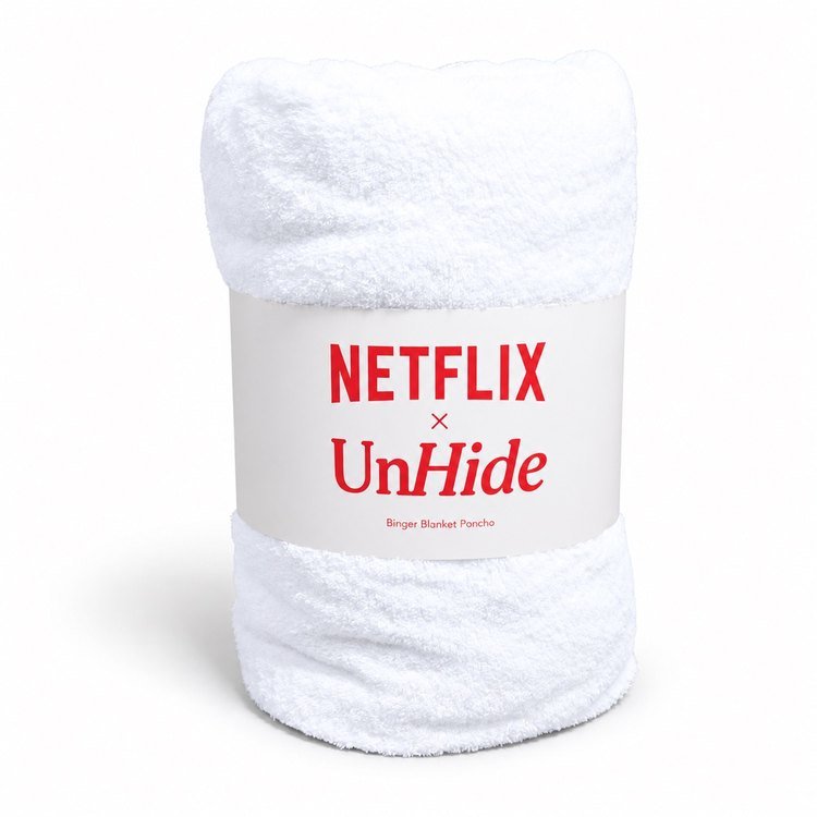 Rolled white towel secured with a printed paper band on a white background