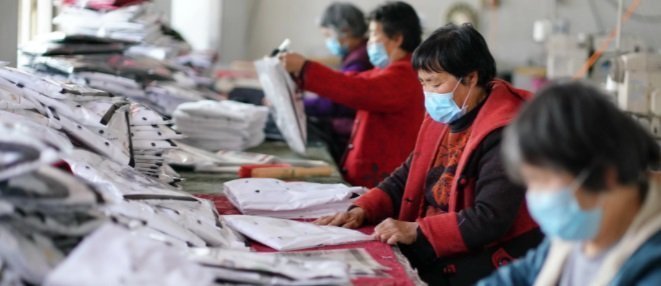 Workers inspecting and preparing textile products